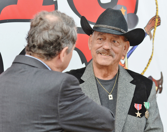 Jeff Lange | The Vindicator  Veteran Thomas Ducharme (facing) speaks with Senator Sherrod Brown after receiving awards for his service in the Army during the Vietnam War, Monday morning in Warren.