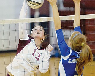 Boardman’s Krista Johnson (13) goes for a kill against the outstretched arms of Lakeview’s Alania Lytle during the
Spartans’ matchup against the Bulldogs on Tuesday night at Boardman High School.