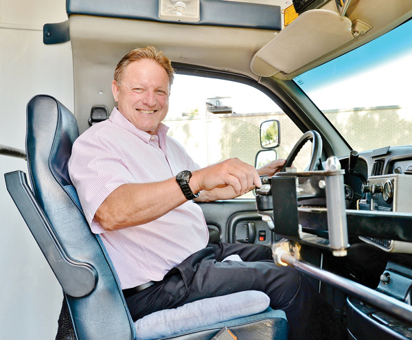 Struthers Mayor Terry Stocker sits in the driver’s seat of the new senior van, which city officials purchased from the village of Lowellville. They were able to do so with a donation from the Struthers Community Chest.