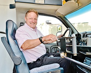 Struthers Mayor Terry Stocker sits in the driver’s seat of the new senior van, which city officials purchased from the village of Lowellville. They were able to do so with a donation from the Struthers Community Chest.
