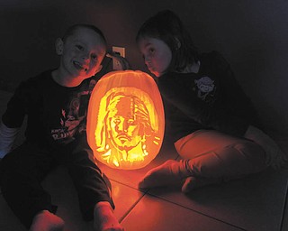 6. In this photo are Sawyer and Addison Williams with the Pirate (is it really Johnny Depp?) carved by Jamie Williams of Austintown..