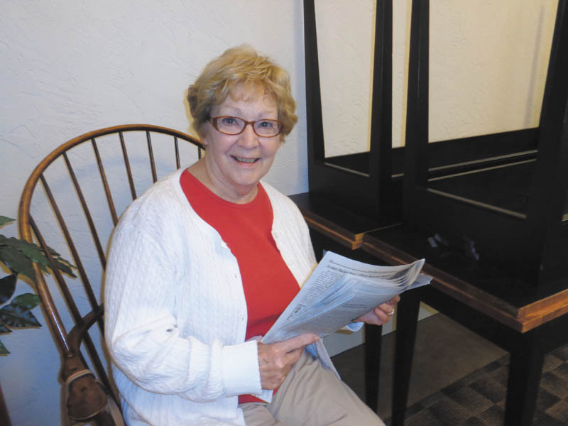 SPECIAL TO THE VINDICATOR
Diane Koch, editor of the Voter Information Guide, looks over the latest edition, published by the League of Women Voters of Greater Youngstown. The publication is free and contains information on candidates and issues for the November election. The guide is available at www.lwvohio.org.