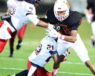 MASSILLON, OHIO - OCTOBER 3, 2014: Tre'on Vance #39 of Massillon is tackled by Mike Pearson #3 and Darrell Jackson #21 of Fitch during the 1st half of Friday nights OHSAA football game at Massillon Washington High School. (Photo by David Dermer/Youngstown Vindicator)