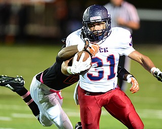 MASSILLON, OHIO - OCTOBER 3, 2014:Tyler Hewlett #31 of Fitch is tackled while running the football by Tobias Evans #28 of Massillon during the 1st half of Friday nights OHSAA football game at Massillon Washington High School. (Photo by David Dermer/Youngstown Vindicator)