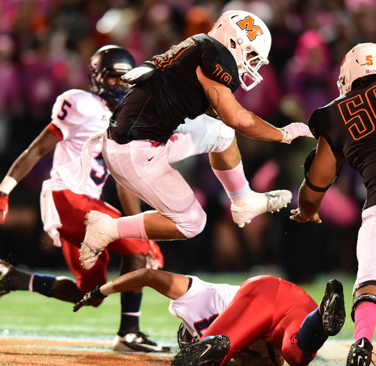 MASSILLON, OHIO - OCTOBER 3, 2014: JD Crabtree #19 of Massillon Hurdles over Jovet Rodriguez #68 of Fitch during the 1st half of Friday nights OHSAA football game at Massillon Washington High School. (Photo by David Dermer/Youngstown Vindicator) Fitch Carlos Herriott pictured.