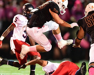 MASSILLON, OHIO - OCTOBER 3, 2014: JD Crabtree #19 of Massillon Hurdles over Jovet Rodriguez #68 of Fitch during the 1st half of Friday nights OHSAA football game at Massillon Washington High School. (Photo by David Dermer/Youngstown Vindicator) Fitch Carlos Herriott pictured.