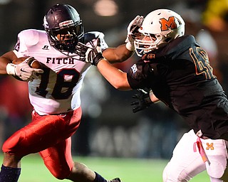 MASSILLON, OHIO - OCTOBER 3, 2014: Antwan Harris #18 of Fitch stiff arms Dakota Dunwiddie #48 of Massillon during the 1st half of Friday nights OHSAA football game at Massillon Washington High School. (Photo by David Dermer/Youngstown Vindicator)