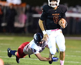 MASSILLON, OHIO - OCTOBER 3, 2014: Danny Clark #6 of Massillon is tackled by a diving Bryce Warmouth #34 of Fitch on a draw play during the 1st half of Friday nights OHSAA football game at Massillon Washington High School. (Photo by David Dermer/Youngstown Vindicator)