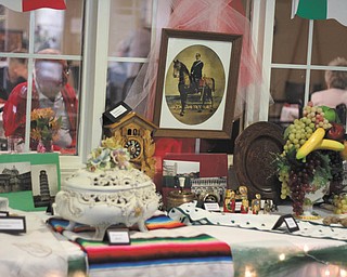 DUSTIN LIVESAY | THE VINDICATOR
Briarfield Inn at Glenellen in North Lima featured a Trip Around the World Day on Aug. 15 with ethnic food from Italy, Mexico, Slovakia and Poland. The food was provided by the dietary department. Above is a table displaying artifacts of various nationalities, which were arranged by the activity department. Below a resident examines one of the items.