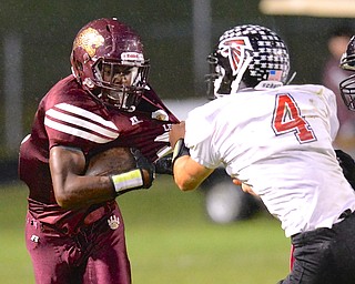 Jeff Lange | The Vindicator  Liberty's Ben Phillips (left) is pulled down by his jersey by Falcons' Lucas Hitchcock during first half action at Liberty High.