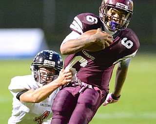 Jeff Lange | The Vindicator  Liberty's Lynn Bowden (6) runs as he's brought down by Lucas Hitchcock in the first quarter of Friday night's game in Liberty.