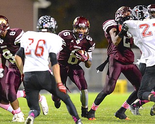 Jeff Lange | The Vindicator  Liberty's Lynn Bowden breaks through the line for a small gain between a host of Falcon and Leopard players.