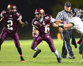 Jeff Lange | The Vindicator  Lynn Bowden of Liberty (6) breaks free from Falcons' Lucas Hitchcock on a gain in the second quarter during Friday night's contest in Liberty.