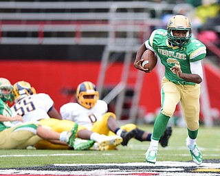 YOUNGSTOWN, OHIO - OCTOBER 4, 2014: Kimauni Johnson #3 of Ursuline runs the football away from a pack of Farrell defenders during the 1st half of Saturday afternoon game at Stambaugh Stadium. (Photo by David Dermer/Youngstown Vindicator)