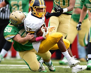 YOUNGSTOWN, OHIO - OCTOBER 4, 2014: Terrell Atkins #22 of Farrell is tackled by Michael Krause #58 of Ursuline during the 1st half of Saturday afternoon game at Stambaugh Stadium. (Photo by David Dermer/Youngstown Vindicator)