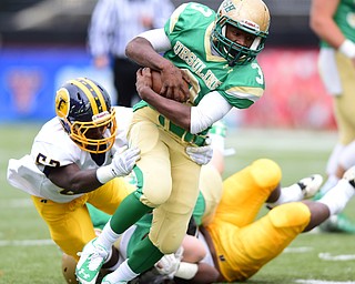 YOUNGSTOWN, OHIO - OCTOBER 4, 2014: Kimauni Johnson #3 of Ursuline runs the ball while slipping the tackle from Chase Butler #52 of Farrell during the 1st half of Saturday afternoon game at Stambaugh Stadium. (Photo by David Dermer/Youngstown Vindicator)