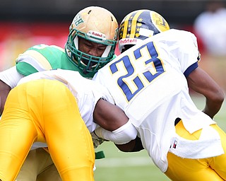 YOUNGSTOWN, OHIO - OCTOBER 4, 2014: Kimauni Johnson #3 of Ursuline is tackled by Braxton Chapman #23 and Malachi Newell #5 of Farrell during the 1st half of Saturday afternoon game at Stambaugh Stadium. (Photo by David Dermer/Youngstown Vindicator)