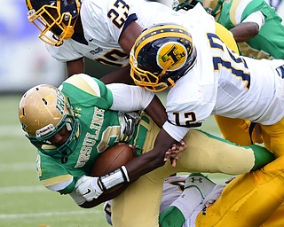 YOUNGSTOWN, OHIO - OCTOBER 4, 2014: Kimauni Johnson #3 of Ursuline is tackled by Braxton Chapman #23, Malachi Newell #5, and Angelo Jackson #12 of Farrell during the 1st half of Saturday afternoon game at Stambaugh Stadium. (Photo by David Dermer/Youngstown Vindicator)