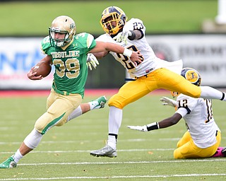 YOUNGSTOWN, OHIO - OCTOBER 4, 2014: Vito Penza #39 of Ursuline runs the football after breaking the arm tackles from Braxton Chapman #23 and Angelo Jackson #12 of Farrell during the 1st half of Saturday afternoon game at Stambaugh Stadium. (Photo by David Dermer/Youngstown Vindicator)