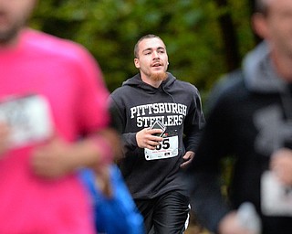 Jeff Lange | The Vindicator  Matt Miller of Struthers trails behind the pack during Saturday morning's Hustle 4 Heart Reach 5K run in Boardman Park.