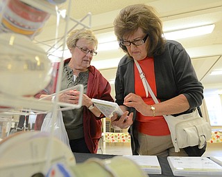 Jeff Lange | The Vindicator  Barb Dellesky of Austintown (left) helps Gloria Cellio of Youngstown pick out stamps at the St. James Episcopal Church, Saturday afternoon.