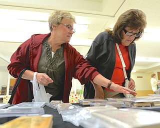 Jeff Lange | The Vindicator  Barb Dellesky of Austintown (left) helps Gloria Cellio of Youngstown pick out stamps at the St. James Episcopal Church, Saturday afternoon.