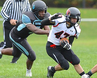 Jeff Lange | The Vindicator  Canfield's CJ Frost (right) rushes past East's TaBrian Donlow early in the second quarter during their matchup, Saturday afternoon.