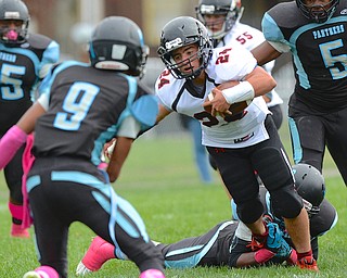 Jeff Lange | The Vindicator  Canfield's Luke Whittenberger (24) runs for yards through a host of Panthers defenders during Saturday's football game at Rayen Stadium.