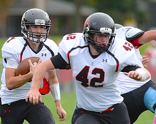 Jeff Lange | The Vindicator  Jake Cummings of Canfield (left) runs for yards behind Cody Holland in the first half of Saturday's matchup with the East Panthers.