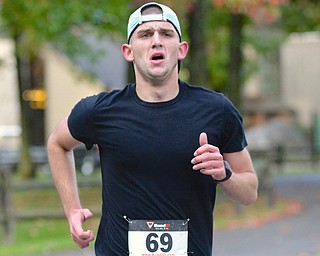 Jeff Lange | The Vindicator  Anthony Costa of Austintown runs on the trail on his way into the woods of Saturday's race in Boardman. He went on to take first place in the Hustle 4 Heart Reach with a time of 18:50.6.