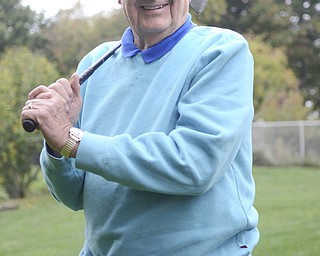 Katie Rickman | The Vindicator.Joe Skeba, a Korean War Veteran, poses with the club that he used when he participated in the "Tee Tournament" in Iowa City, Iowa where he got a hole-in-one...he poses at his home Wednesday, Oct. 1, 2014. He is considered legally blind and resides in Boardman.