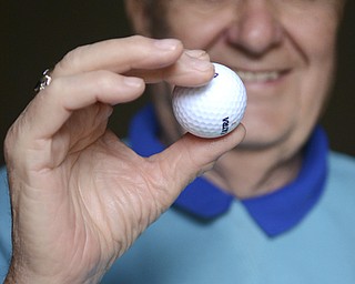 Katie Rickman | The Vindicator.Joe Skeba, a Korean War Veteran, poses with the golf ball that he used when he got a hole-in-one at a tournament for blind and disabled Veterans in Iowa earlier this year Oct. 1, 2014. He is considered legally blind and resides in Boardman.