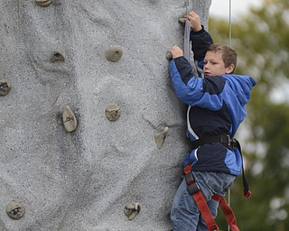 Katie Rickman | The Vindicator.Nick Moliterno, 12 of Austintown climbs the rock wall and rings the bell at the top at "Awesometown Oktoberfest" at the Township Park in Austintown on Sunday, Oct. 5, 2014.