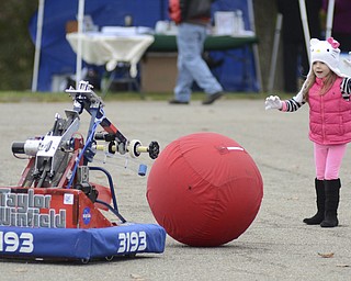 Katie Rickman | The Vindicator.Ava Lombardo spends time playing with Austintown's Robotic team robot during "Awesometown Oktoberfest" at the Township Park in Austintown on Sunday, Oct. 5, 2014.