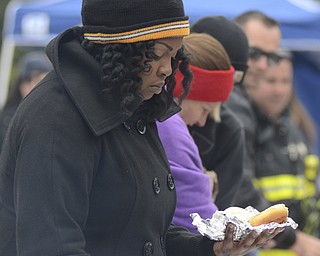 Katie Rickman | The Vindicator.Jada Yancy of Austintown prepares a hamburger to eat at  the Township Park in Austintown on Sunday, Oct. 5, 2014.