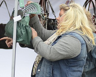Katie Rickman | The Vindicator.Tami McCreery looks at a purse being sold at "Awesometown Oktoberfest" at the Township Park in Austintown on Sunday, Oct. 5, 2014.
