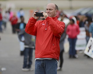 Katie Rickman | The Vindicator.Youngstown Mayor John McNally takes a photo of parade participants during the 5th Annual Nonviolence Parade on Sunday, Oct. 5, 2014. A rally followed the parade which traveled from Wood St. in Youngstown, down Wick Ave. and ended at the Covelli Centre.