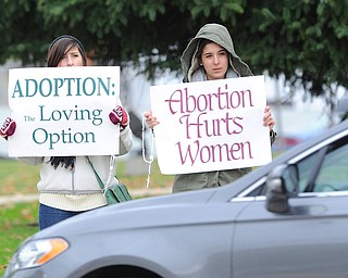 Jeff Lange | The Vindicator  Julia Bowman (left) and Maria Ruiz, members of St. Elizabeth Annseton Parish in Warren hold pro-life signs for drivers to see during Sunday's 24th annual Life Chain in the streets of Warren.