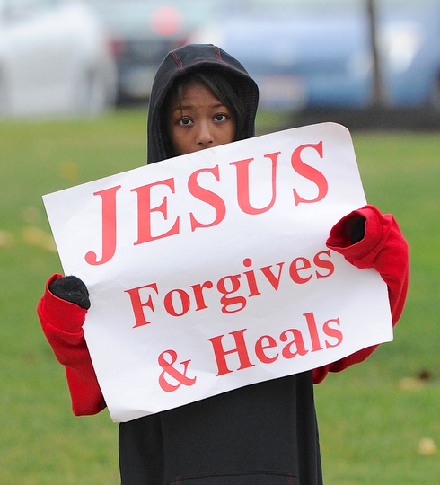 Jeff Lange | The Vindicator  Faith Rush of Warren braves Sunday's cold weather to give drivers a friendly reminder during the 24th annual Life Chain in Warren.