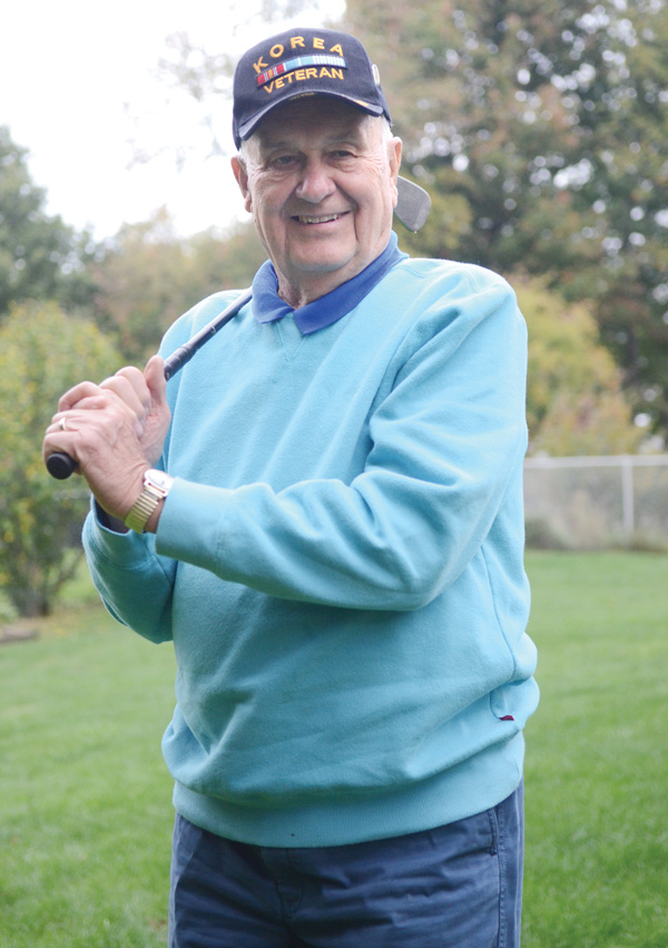 Joseph Skebo, a Korean War veteran, holds the club he used when he made a hole-in-one in the National Veterans TEE Tournament in Iowa City in September. Skebo, 83, of Boardman, is considered legally blind.