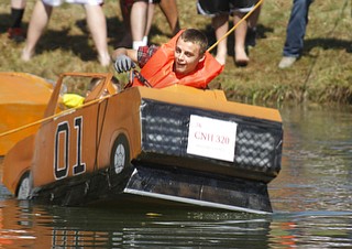        ROBERT K. YOSAY  | THE VINDICATOR.."DUKES OF HAZARD pulls a wheelie as Colin Razo and Dante Pecchia (yellow vest take off..The Annual Raider  Regatta done annually by 10th grade students at Memorial Park behind the old high School ...-30-