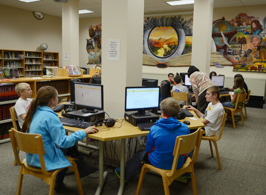 Katie Rickman | The VindicatorSixth graders at Poland McKinley Elementary School work on computers in the library at the school on Monday, October 6, 2014.  Poland Elementary School students use computers to do math and language arts homework and tests.