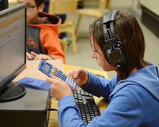 Katie Rickman | The Vindicator.Kyle Posey, a sixth grader at Poland McKinley Elementary School uses her calculator while doing math problems on a computer in the library at the school on Monday, October 6, 2014.  Poland Elementary School students use computers to do math and language arts homework and tests.
