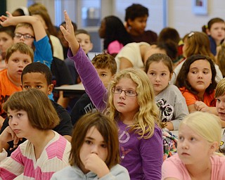 Katie Rickman | The Vindicator.Mary Williams, center, a fourth grader at Struthers Elementary School raises her hand during a question and answer portion of the fire safety assembly at the school on Tuesday, Oct. 7, 2014. The third and fourth grade students were able to ask questions about how to react if there were a fire.