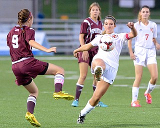 Jeff Lange | The Vindicator  Canfield senior captain Sydney Miller (with ball) kicks the ball down field under pressure from Boardman's Payton Bryant (9) during first half action at Bob Dove Field, Monday night.
