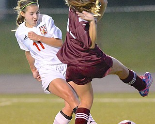Jeff Lange | The Vindicator  Boardman's Heaton O'Hara jumps out of the way as Canfield's Haylee Klacik kicks the ball towards the goal during first half action in Canfield, Monday evening.