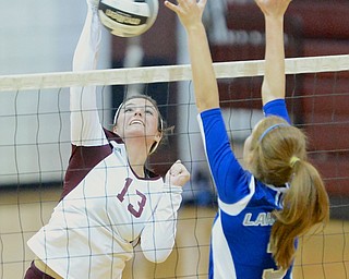 Jeff Lange | The Vindicator  Boardman Krista Johnson (13) spikes the ball over the net as Lakeview's Alania Lytle jumps to defend the ball during Boardman's matchup against the Bulldogs, Tuesday night.