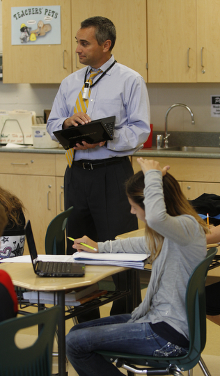        ROBERT K. YOSAY  | THE VINDICATOR..South Range Schools with Superintendent .Dennis Dunham.. has used a varitey of new educational tools to increase learning and decrease costs saving over 70000 dollars.... .Math Teacher Jeff Hammond uses a net  book in his class .student is Carlie Boyd .-30-