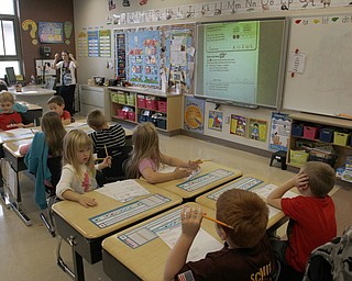        ROBERT K. YOSAY  | THE VINDICATOR..South Range Schools with Superintendent .Dennis Dunham.. has used a varitey of new educational tools to increase learning and decrease costs saving over 70000 dollars.... Lisa Fullerton uses a smart board and "elmo document projector" to teach and have students interact easily..-30-