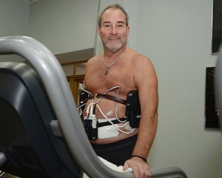 Katie Rickman | The Vindicator.Tom Lawrence of Boardman walks on a treadmill at the YMCA of Youngstown on Thursday, Oct. 2, 2014. He is currently on a heart transplant waiting list at Cleveland Clinic and until he receives his heart he wears a L-VAD heart pump that keeps his heart going. He works out frequently, despite his heart condition, at the YMCA  in Youngstown  onThursday, Oct. 2, 2014.